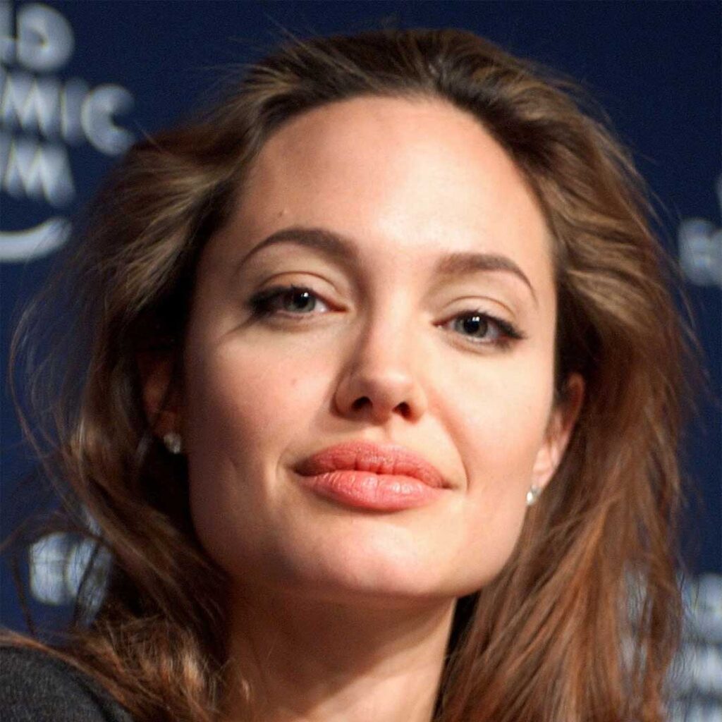 Angelina Jolie has a square face shape, characterized by a strong jawline, broad forehead, and sharp, angular features that give her a striking and defined appearance.