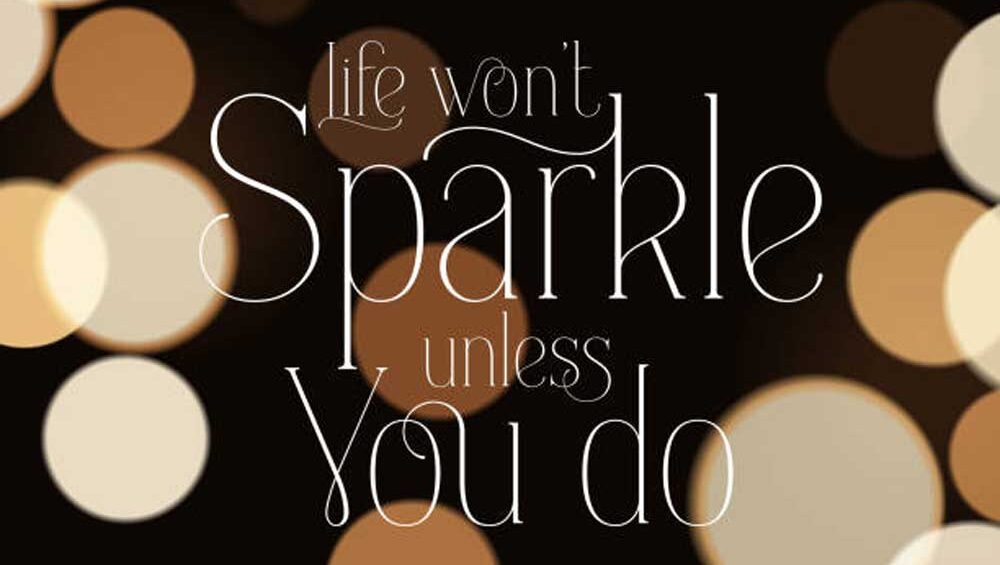 Inspirational quote ‘Life won’t sparkle unless you do’ on a glowing bokeh background, symbolizing strength and empowerment.