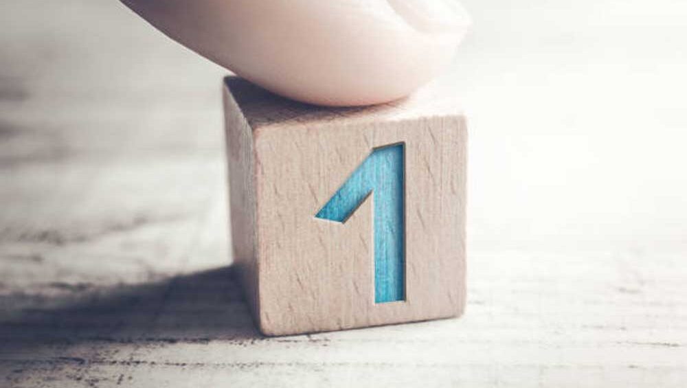Wooden block with a bold blue number "1," symbolizing uniqueness and rarity.