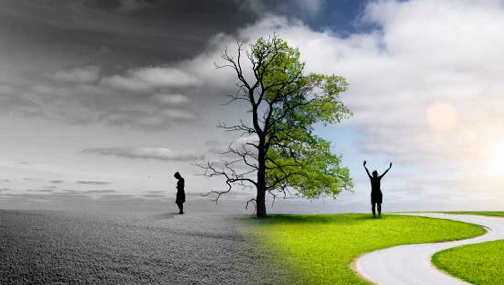 A tree stands at the divide between a dark, barren landscape with a lonely figure and a bright, green path where another person walks toward the light, symbolizing the journey from toxic love to emotional fulfillment.