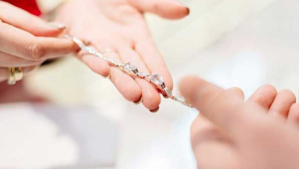 Hands exchanging a delicate bracelet, symbolizing trust and connection in a jewelry business.