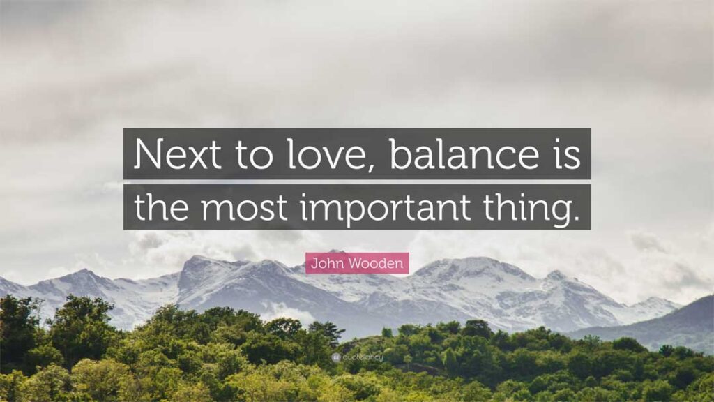 Quote by John Wooden: 'Next to love, balance is the most important thing,' displayed over a scenic mountain landscape.