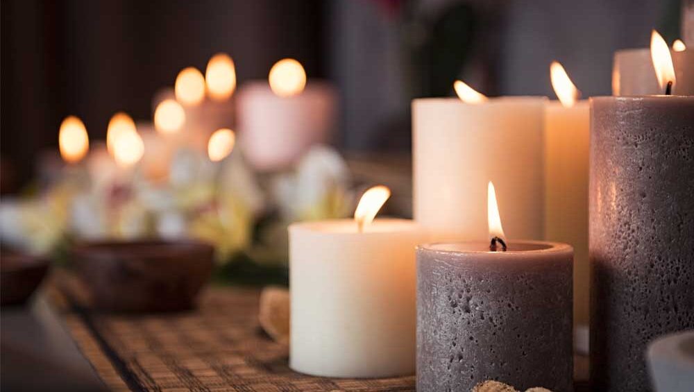 Softly glowing candles on a table, creating a warm and peaceful ambiance.