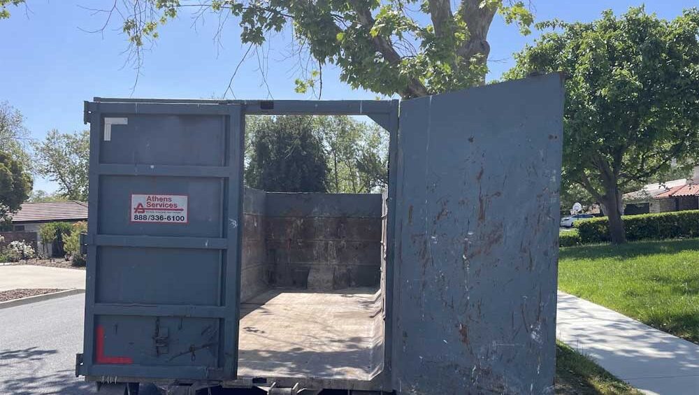 Empty 30-yard dumpster in sunlight, symbolizing emotional release and personal empowerment