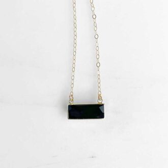 Faceted black onyx bar necklace on a delicate 14K gold-filled chain, styled against a clean white background.