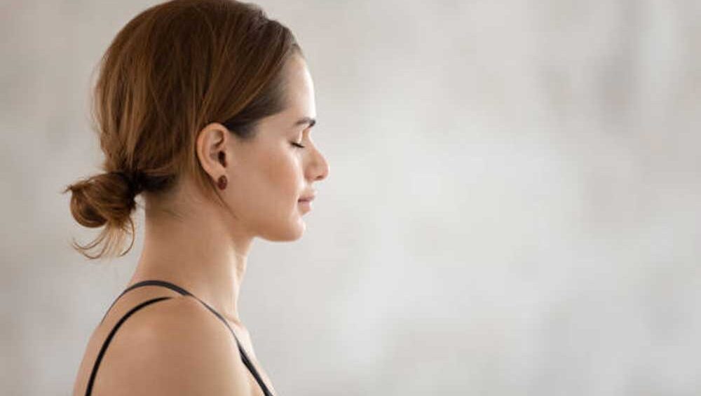 Woman in profile with eyes closed, centered in calm strength, reflecting emotional clarity and inner boundaries.