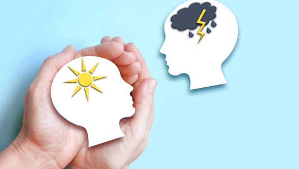 Hands holding a concept of emotional states — sunshine and storm inside the mind.