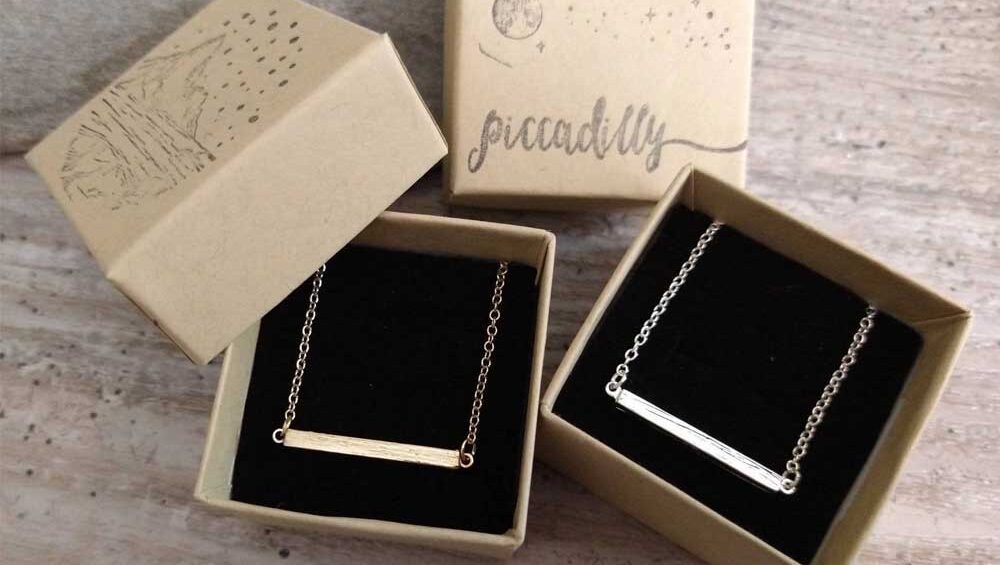 Gold and silver horizontal bar necklaces in eco-friendly gift boxes from Piccadilly