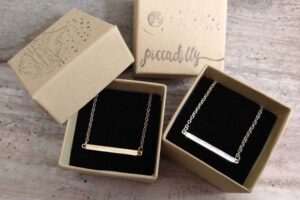 Gold and silver horizontal bar necklaces in eco-friendly gift boxes from Piccadilly