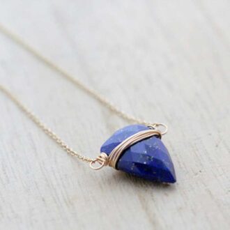 Faceted Lapis Lazuli briolette wrapped in gold-filled wire and suspended horizontally on a delicate chain