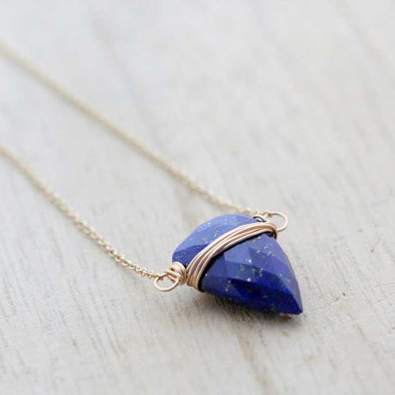 Faceted Lapis Lazuli briolette wrapped in gold-filled wire and suspended horizontally on a delicate chain