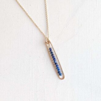 Handmade gold-filled necklace with hammered frame and lapis lazuli beads