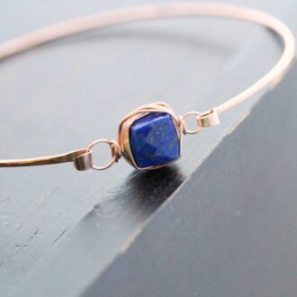 Close-up view of Saressa Designs Lapis Stacking Bracelet showing bezel-wrapped Lapis Lazuli cube on a gold-filled hammered bangle.