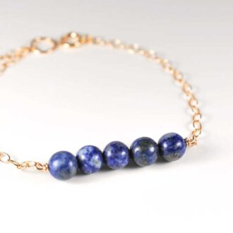 Lapis Lazuli Genesis Bracelet with five blue gemstone beads on a gold-filled chain
