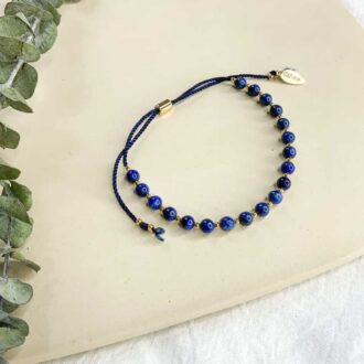Adjustable bracelet with lapis lazuli beads and gold accents on navy cord by Gather Brooklyn