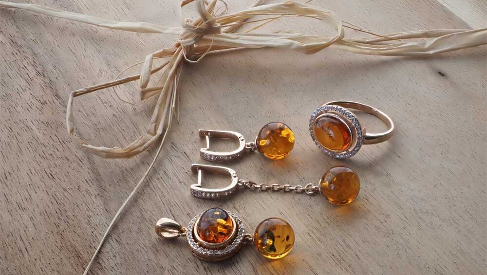 Flat lay of Scandinavian amber jewelry on natural wood, showcasing Nordic minimalism and craftsmanship