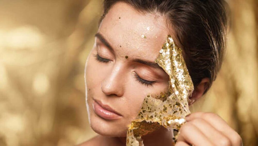 Woman peeling off a golden mask symbolizing the hidden struggles of the golden child in a narcissistic family
