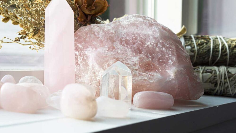 Rose quartz healing crystals on a windowsill promoting love, self-care, and emotional balance