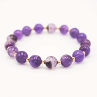 Amethyst stretch bracelet of 8 mm round beads spaced with small gold-filled accents