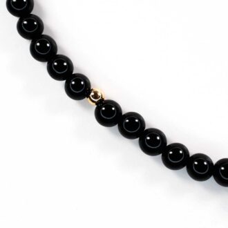 Black Onyx Solo Mini Choker with polished beads and a single gold-filled accent bead.