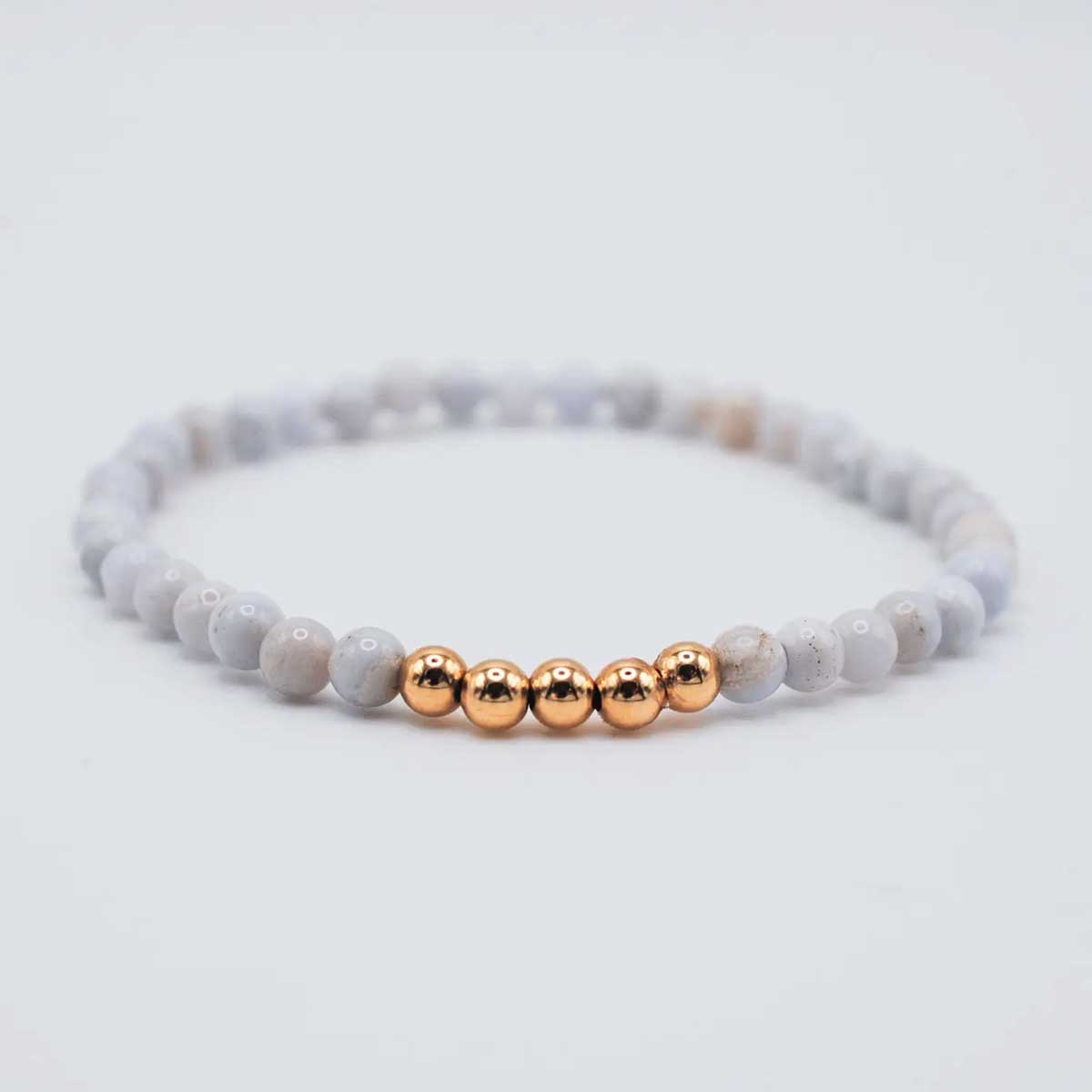 Blue lace agate ascension bracelet with soft blue beads and gold accents.
