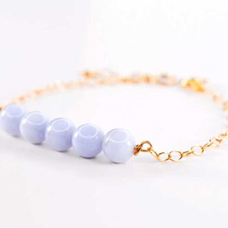 Blue lace agate genesis bracelet with soft blue beads and gold chain.