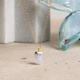 Blue lace agate horn-shaped pendant necklace on a gold chain.