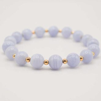 Blue lace agate infinity grande bracelet with soft blue beads and gold accents.