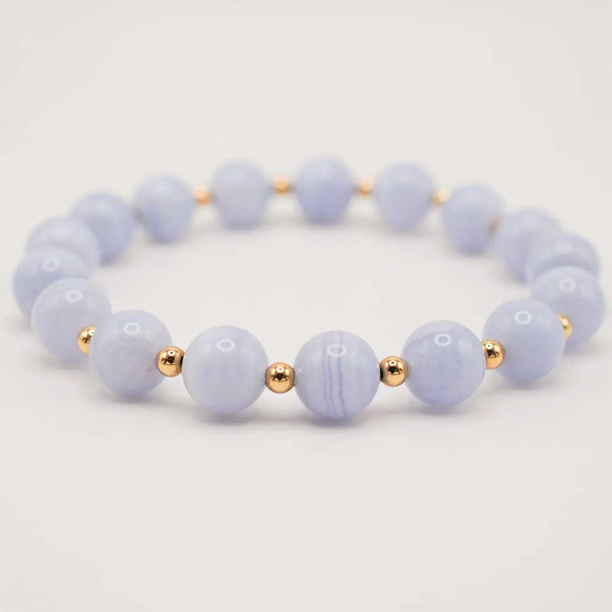 Blue lace agate infinity grande bracelet with soft blue beads and gold accents.