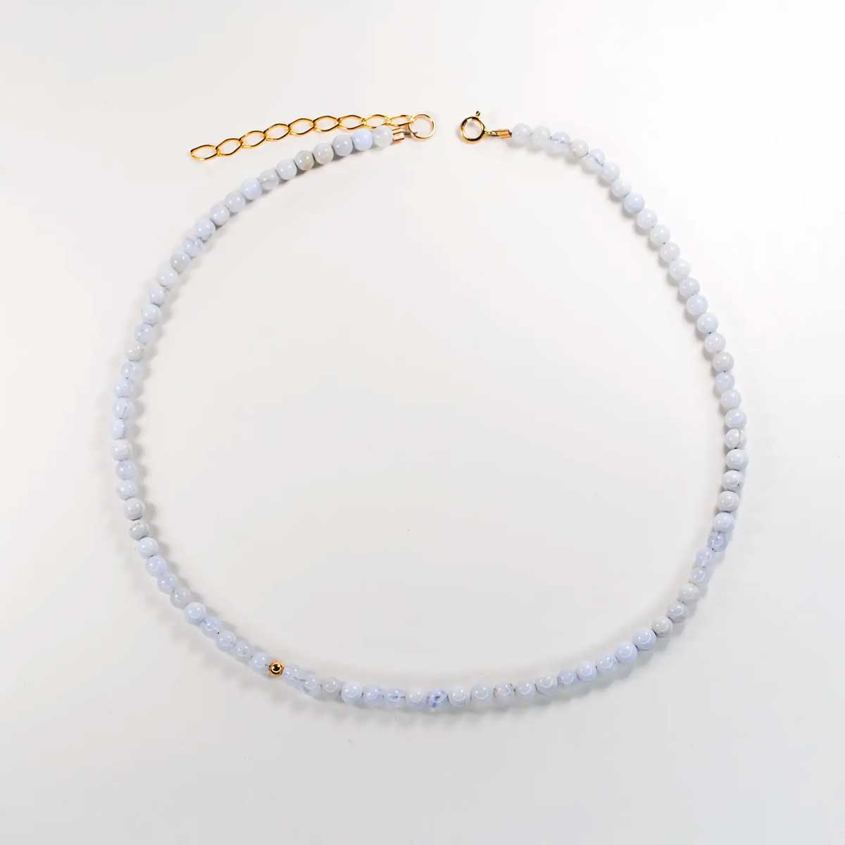 Blue lace agate solo mini choker with delicate pale blue beads and a single gold accent.