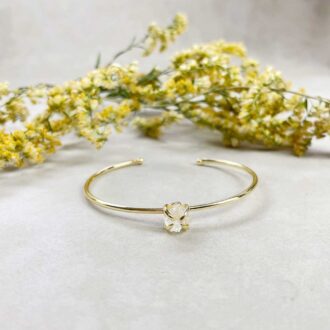 Gold cuff bracelet with rough clear quartz nugget gemstone in prong setting