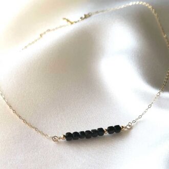 Dainty Black Tourmaline Necklace with 14K gold-filled chain and faceted cube gemstones.