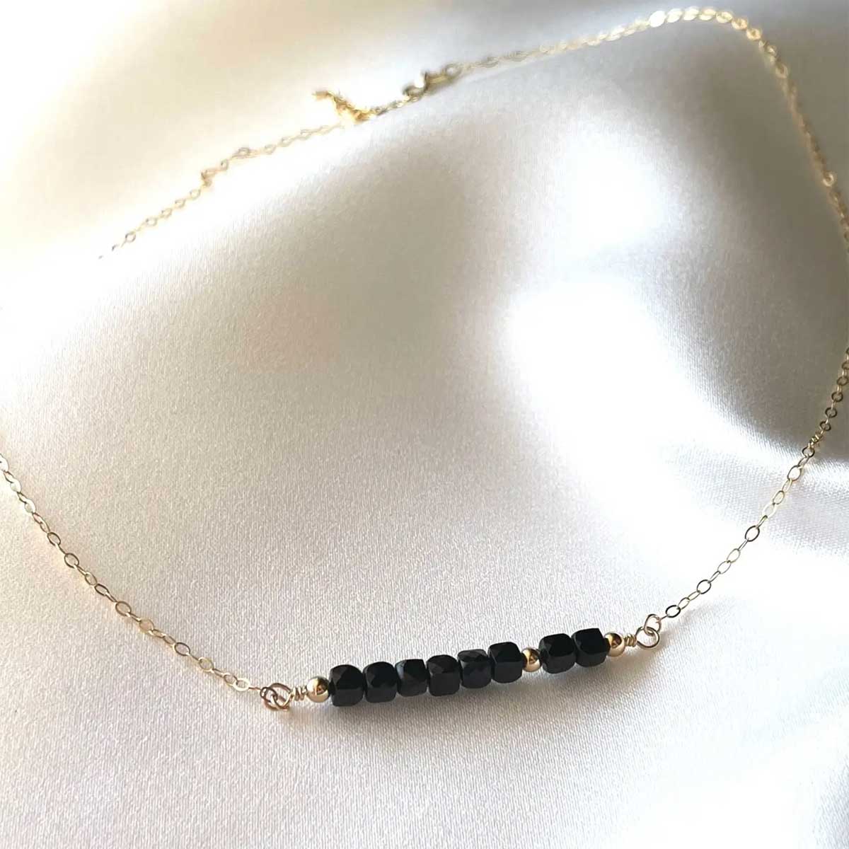 Dainty Black Tourmaline Necklace with 14K gold-filled chain and faceted cube gemstones.