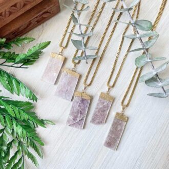 Gold lepidolite slice necklaces with rectangular lavender stones and gold-plated tops, displayed on gold chains.