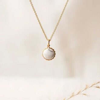 Elegant gold necklace with round howlite pendant, designed for calm, relaxation, and stress relief.