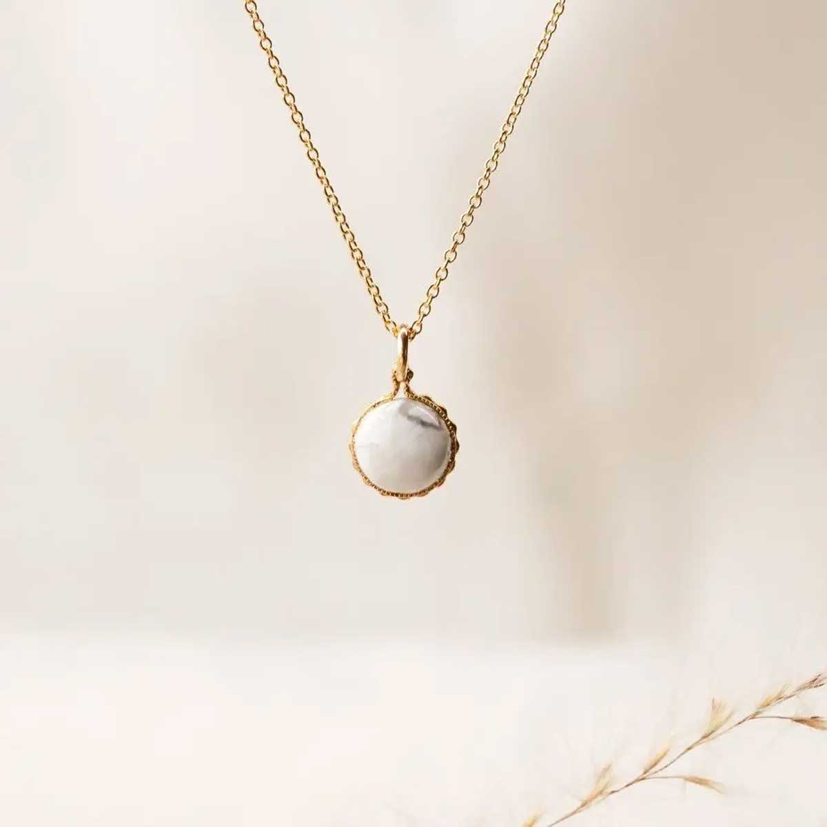 Elegant gold necklace with round howlite pendant, designed for calm, relaxation, and stress relief.
