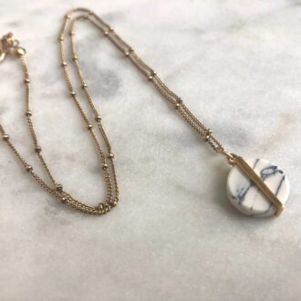 Howlite creation necklace with circular white stone pendant on a delicate gold satellite chain.
