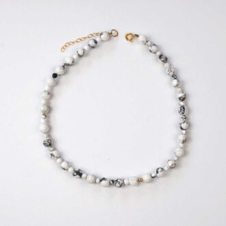 White howlite stone choker with gold accent bead and extender chain, designed for calm, grounding, and balance.