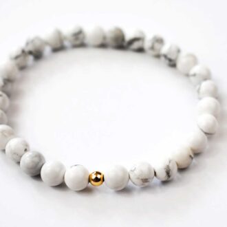 White howlite solo core bracelet with 6mm beads and a single 14k gold filled accent bead, 6.5-inch elastic design for calm and clarity.