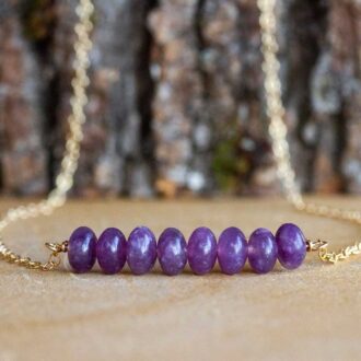 Lepidolite bar necklace with polished purple rondelle beads on a 16-inch gold cable chain, designed for calming energy.