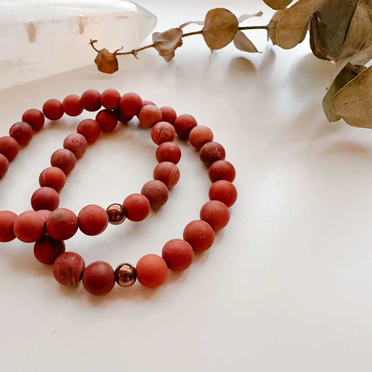Matte Red Jasper beaded bracelet with copper-plated hematite accent bead.