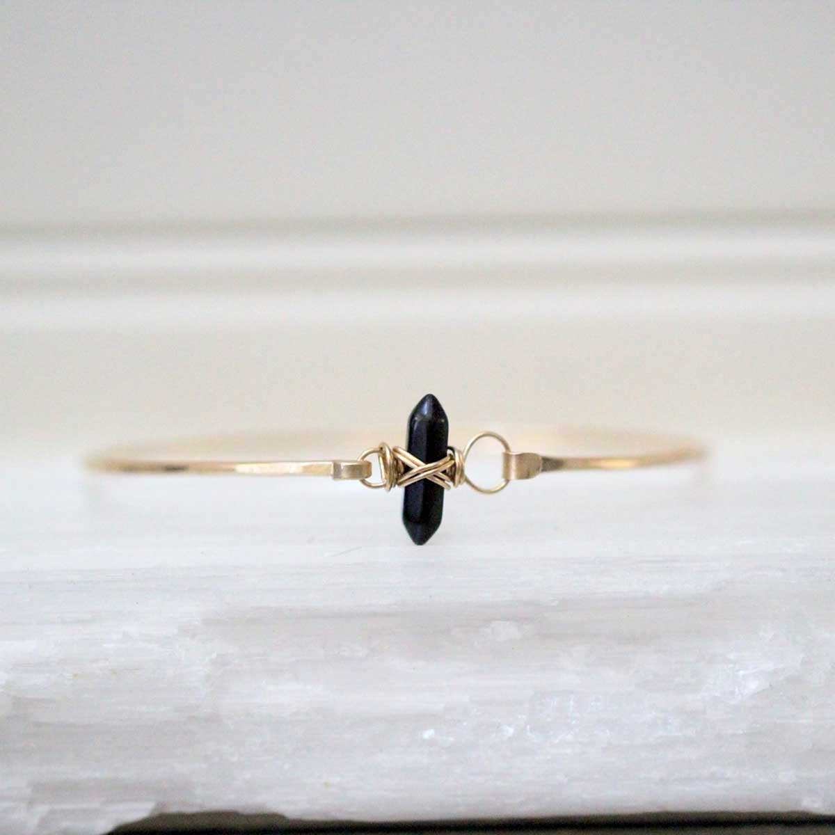 Obsidian Crest Bracelet with gold bangle and double pointed crystal