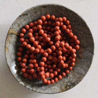 Red Jasper beaded bracelet with polished round stones on a stretch cord.