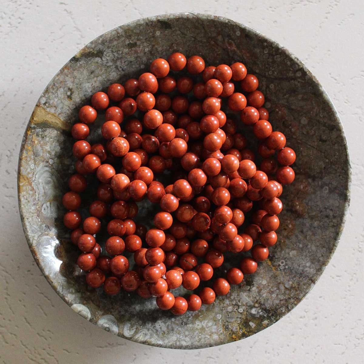 Red Jasper beaded bracelet with polished round stones on a stretch cord.