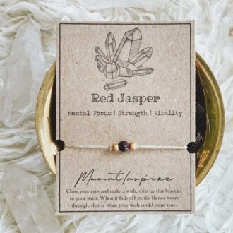 Red Jasper crystal wish bracelet on hemp cord with gold beads and eco-friendly packaging.