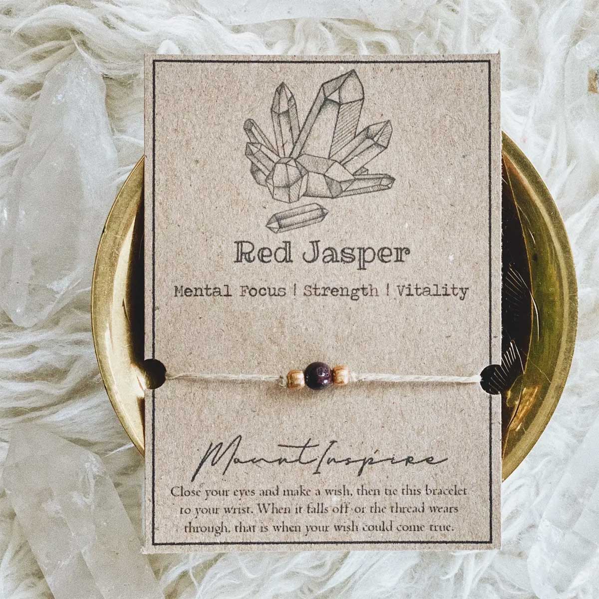 Red Jasper crystal wish bracelet on hemp cord with gold beads and eco-friendly packaging.