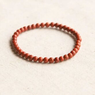 Red Jasper Energy Bracelet with polished gemstone beads on a stretch cord.