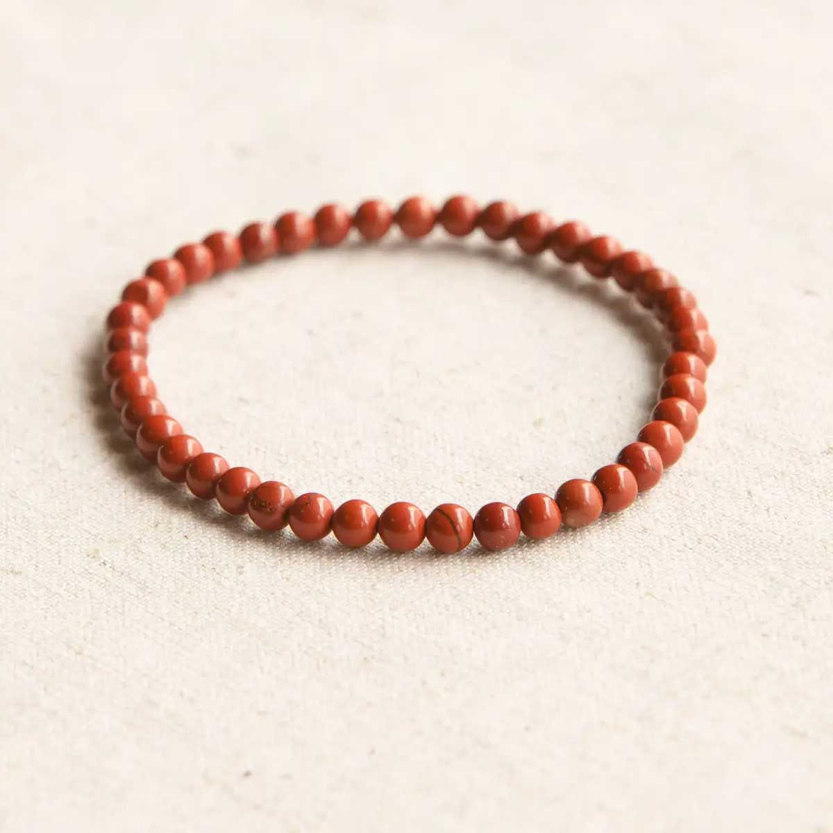 Red Jasper Energy Bracelet with polished gemstone beads on a stretch cord.