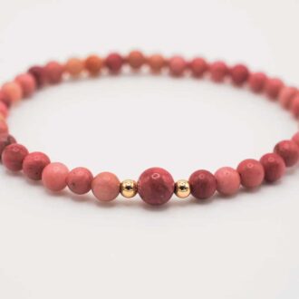 Rhodonite Horizon bracelet with pink gemstone beads and gold-filled accents displayed on a white background.
