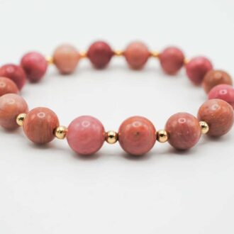 Rhodonite Infinity Grande bracelet with pink gemstone beads and gold-filled accents arranged in a circular design.